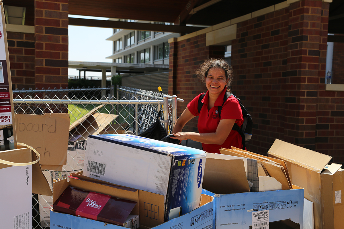 Institutional service assistant Carminda Gomez has a huge smile, despite being ‘up to her waste’ in cardboard.