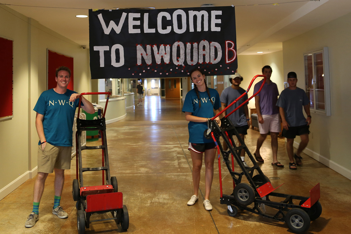 RAs Ryan Cooney and Elrine Goosen welcome students to Northwest Quad B.